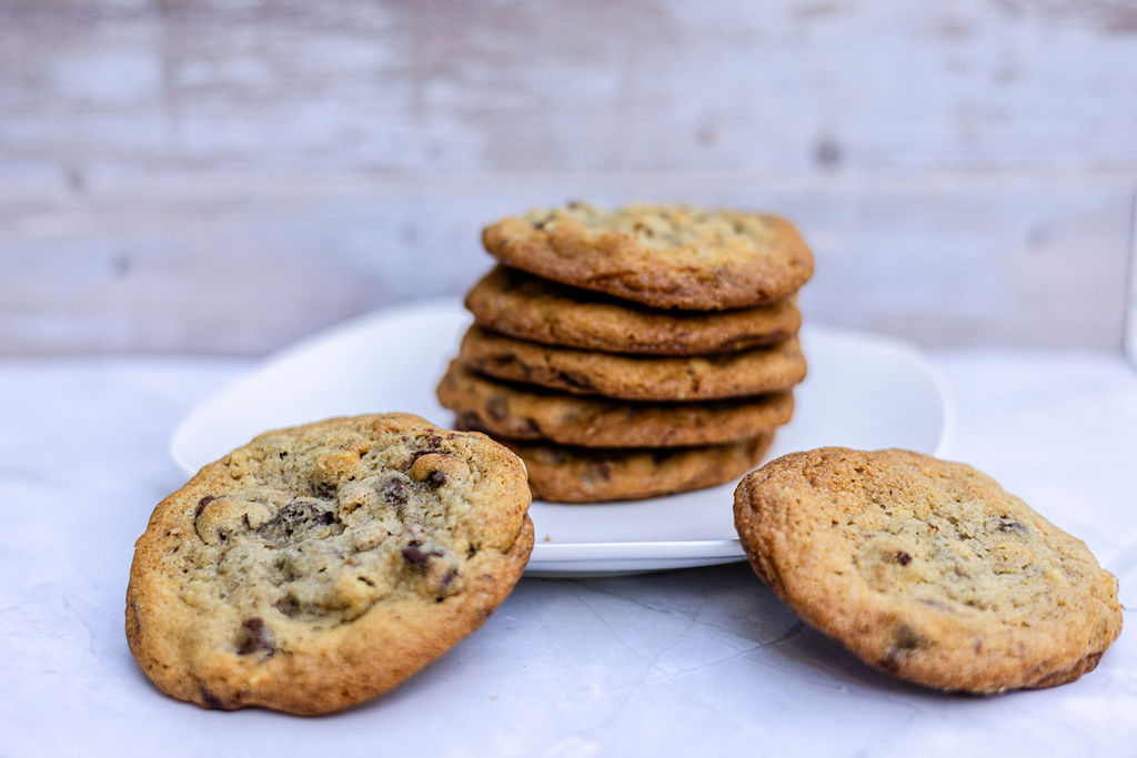 A dozen chocolate chip cookies on a rack